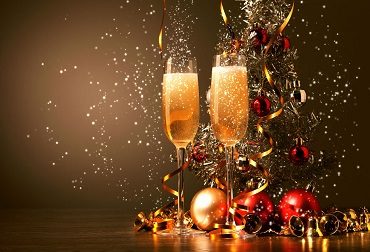 Champagne glasses and red Christmas ornaments